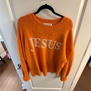 “Jesus” orange sweater